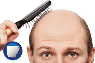 a balding man brushing his hair - with Arkansas icon