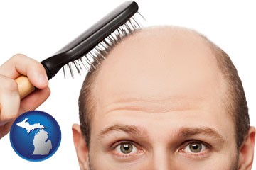 a balding man brushing his hair - with Michigan icon
